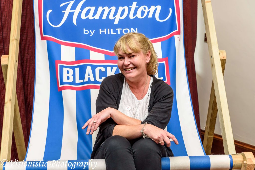 image of blackpool business expo sitting on a white and blue oversized deck chair