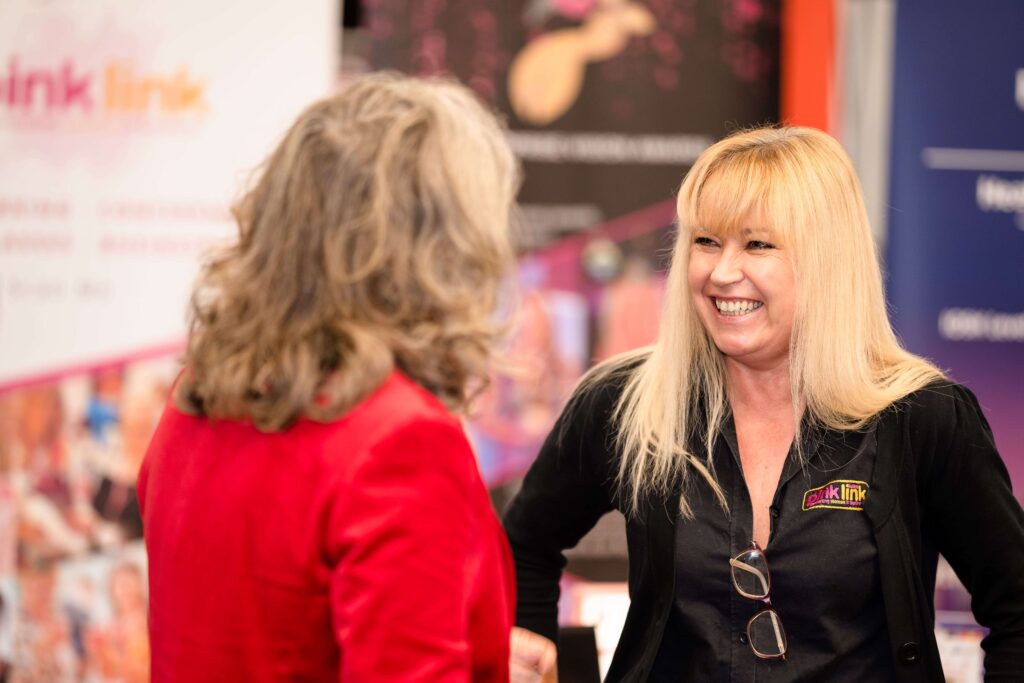 Smiling Coral Horn from Pink Link ladies smiling and chatting to Tina Boden