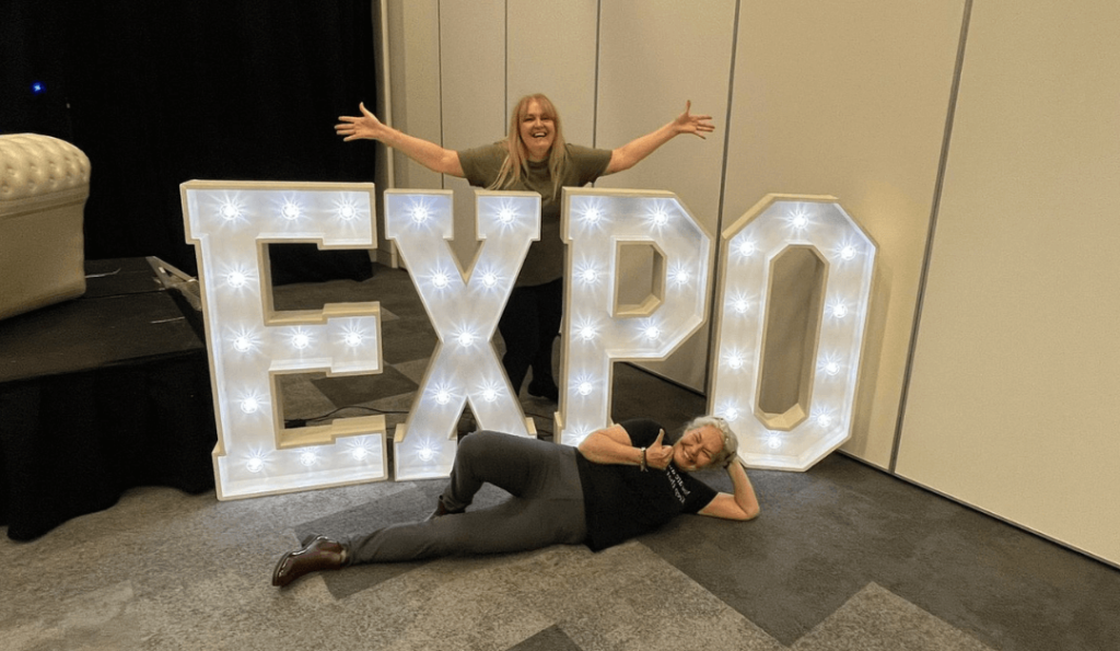 Organisers of Blackpool Business Expo stood with a light up expo sign